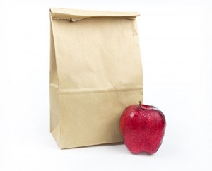 Brown Lunch bag paper with red apple on white background