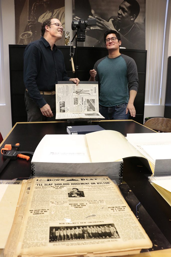 Ben Knysak, left, of RIPM and assistant Gabriel Caballero scanning 1930s issues of Down Beat in October. The effort at IJS is part of an international project to digitize music publications going back to the eighteenth century. Photograph by Mark Papianni.