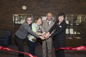 (l. to r.) Associate University Archivist Special Collections and University Archives Erika Gorder, Assistant Vice President for Information Services Director Dee Magnoni, New Brunswick Chancellor Debasish Dutta and Vice President for Information Services and University Librarian Krisellen Maloney cut ribbon for the Carr library image