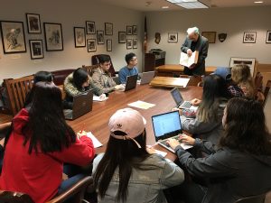 students viewing a book from Special Collections