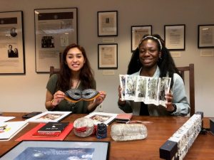 students holding book arts