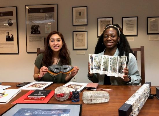 students holding book arts
