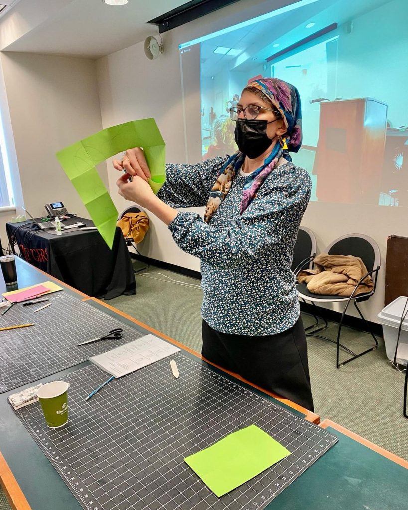 Suzie Tuchman conducts the triangle book-making workshop.