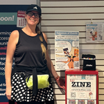 Megan Lotts standing by an exhibit