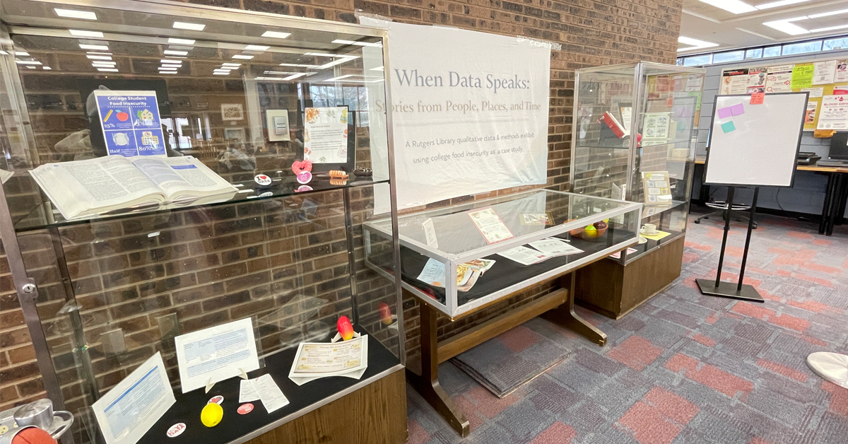 Display cases filled with various objects are lined up against the wall of a room.