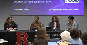 Four panelists sit at a table, facing an audience.