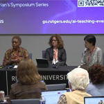 Three panelists sit at a table, facing an audience.