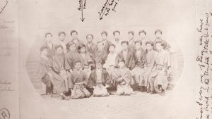 Old, sepia-toned portrait of a group of people