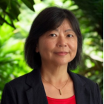 Professional headshot with background of green foliage