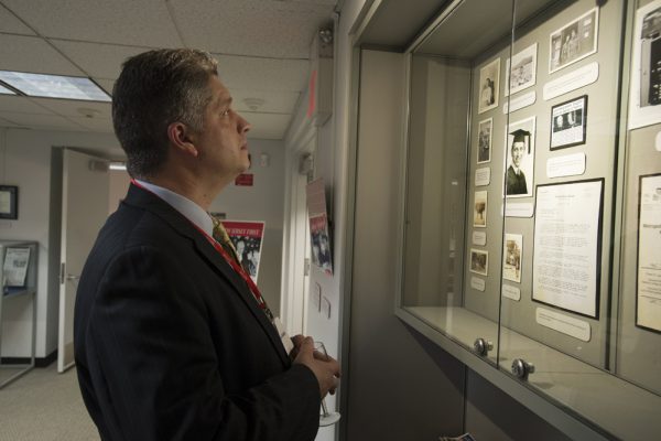 William Ayala looks at the Senator Frank Lautenberg exhibit