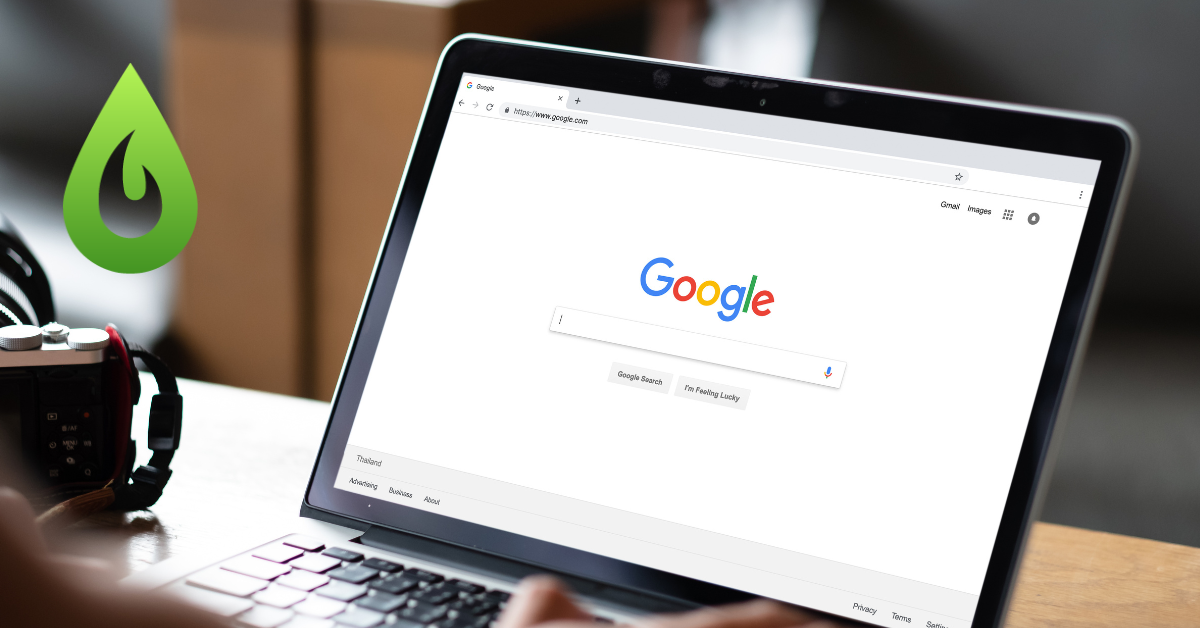 Google home screen showing on a laptop. A green icon shaped like a teardrop sits in the top left corner of the photo.